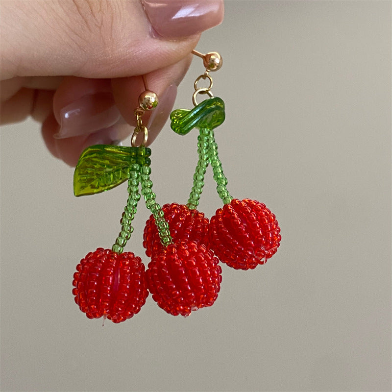 Handmade cherry beaded earrings with red beads and green leaves